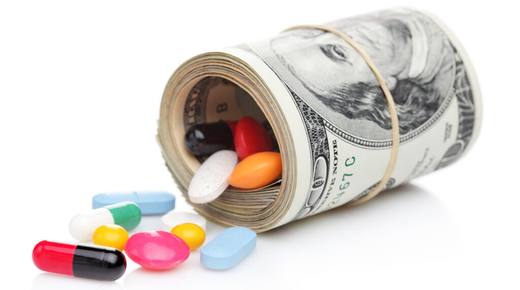 Money rolled up with pills flowing out
