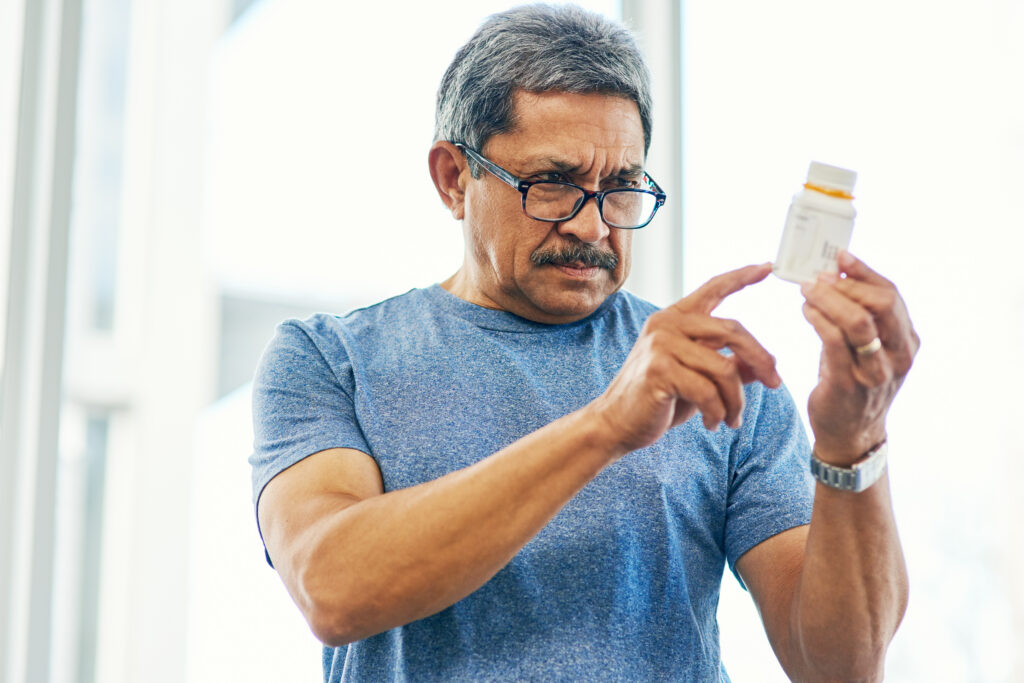 man holding prescription drug